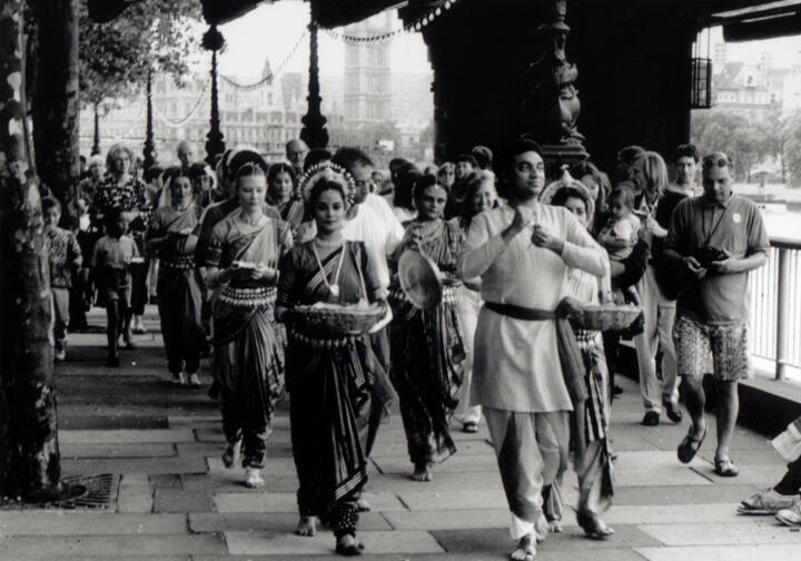 Procession of dancers walk along Southbank